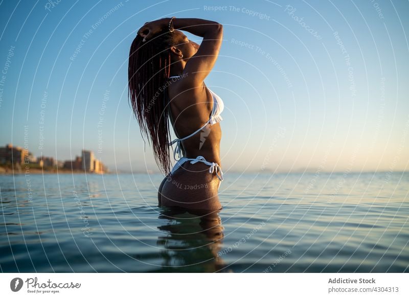 Black woman with braids on the beach bikini summer black african vacation beautiful sea young portrait happy attractive person holiday afro background isolated