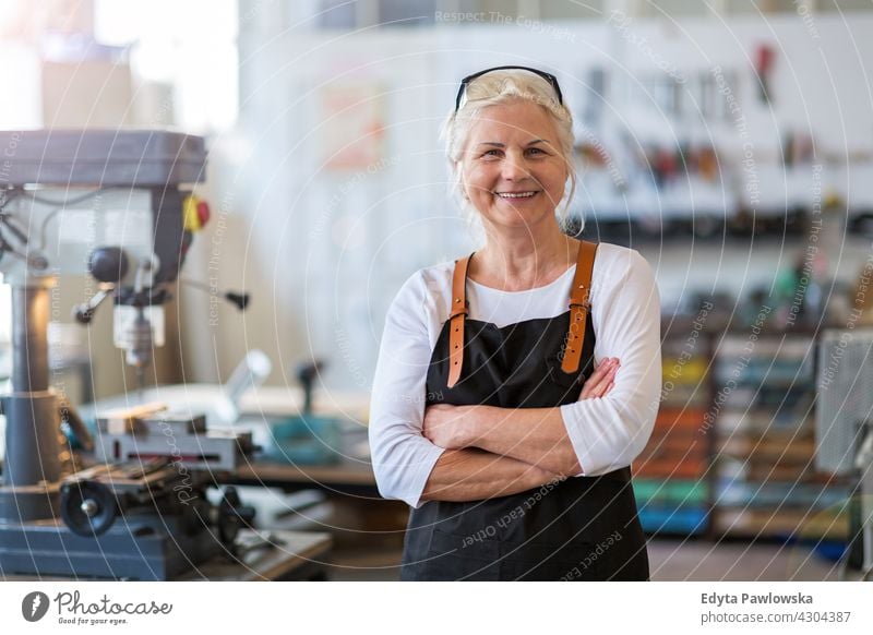 Senior craftswoman in her workshop indoors female mechanic owner profession service small business employee working technician workplace manual worker