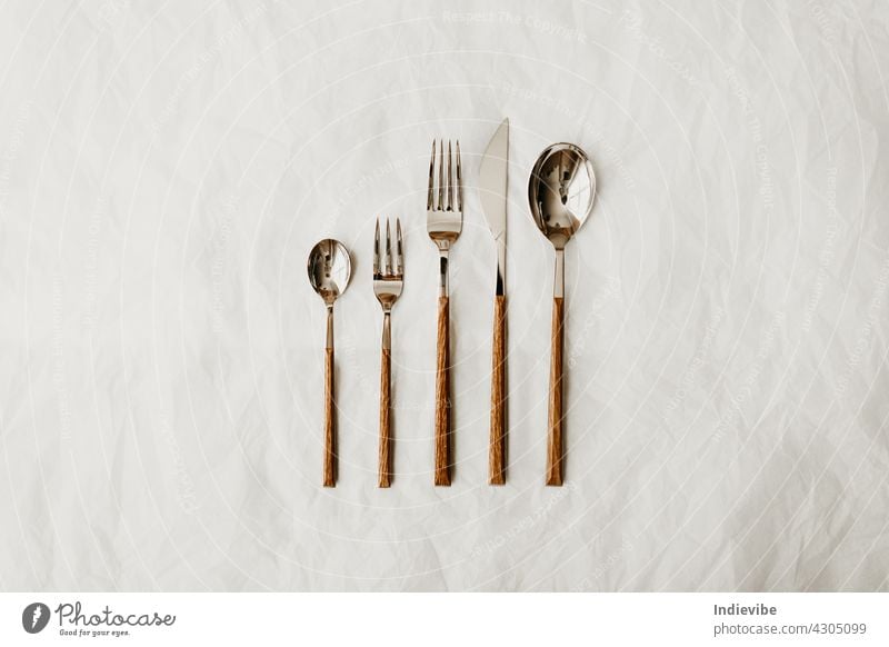 Metal cutlery with wooden handle composition on white background fork knife spoon silverware isolated kitchen table metal food dinner utensil restaurant steel