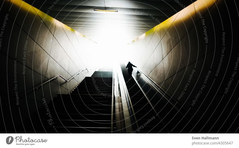 Man climbs a staircase Stairs Staircase (Hallway) Descent step Dark stair treads Stagger Legs Old town Metal Metal grid Metal railings Diagonal light and dark