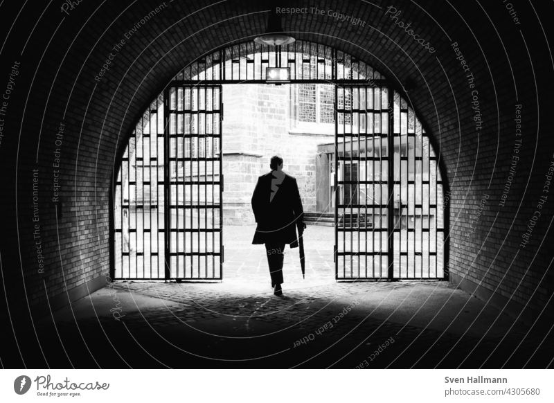 Man walking down a staircase between two imposing buildings Architecture Building Modern architecture Facade Esthetic Symmetry Design Abstract Arrangement Line