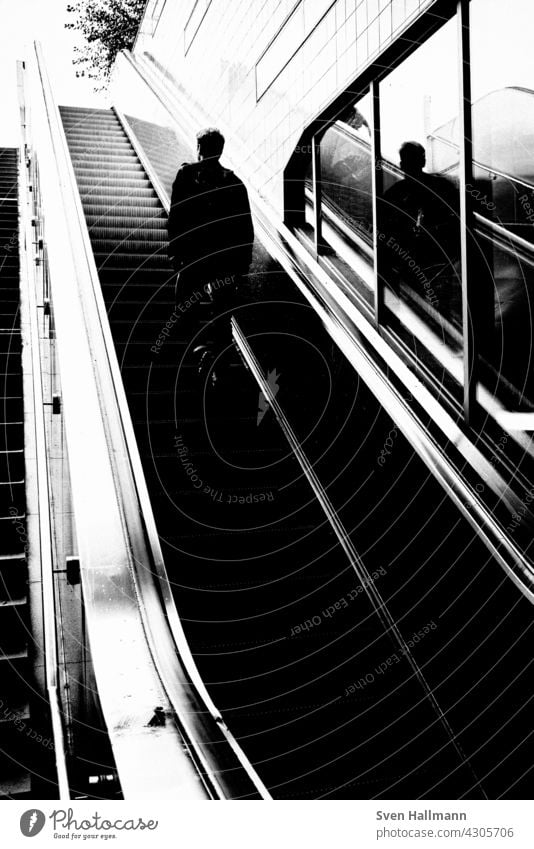 Man walking down a staircase between two imposing buildings Architecture Building Modern architecture Facade Esthetic Symmetry Design Abstract Arrangement Line