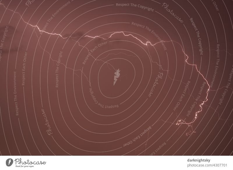 Lightning and thunder in a copper coloured sky during a strong thunderstorm at high altitude Thunder and lightning Rain Clouds Dark Weather Drops of water Wet