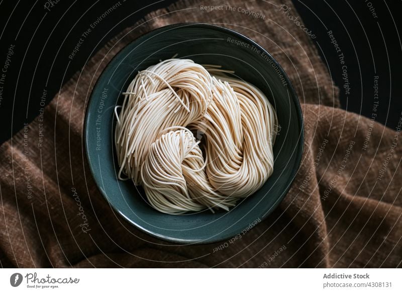 Bowl with raw ramen noodles ingredient cook bowl lunch asian food tablecloth cuisine meal prepare tradition fresh uncooked culinary dish nutrition japanese