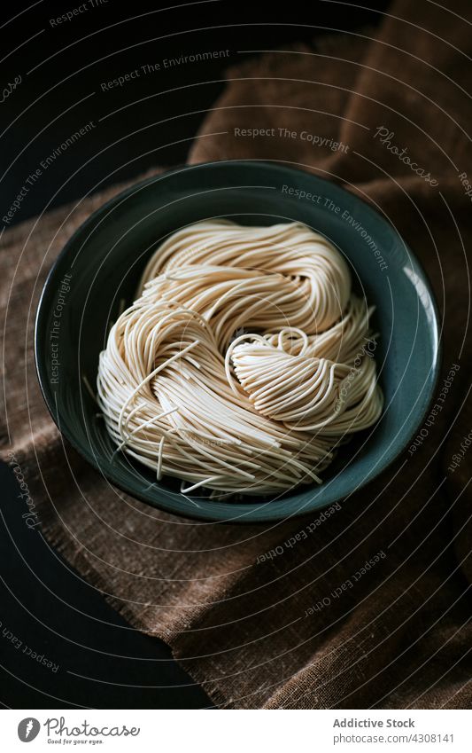 Bowl with raw ramen noodles ingredient cook bowl lunch asian food tablecloth cuisine meal prepare tradition fresh uncooked culinary dish nutrition japanese