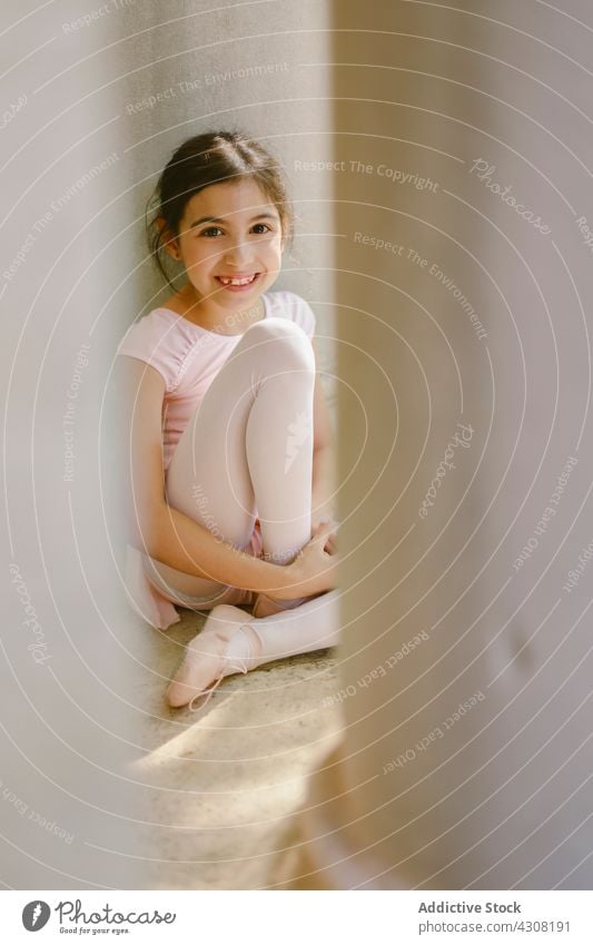 Happy teenage ballerina in pointe shoes in park ballet girl dancer smile talent positive cheerful happy art stone column garden lean glad dress cute charming