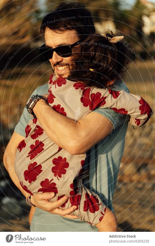 Father hugging daughter in nature father countryside rest weekend carry together love summer man girl happy embrace relationship eyes closed child kid relax