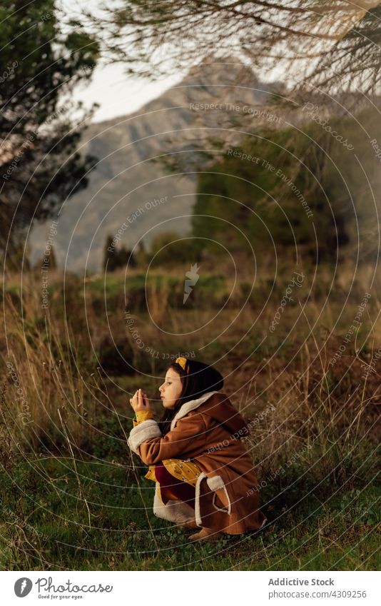 Little kid exploring nature in countryside explore girl alone curious child environment interest childhood meadow mountain little free time lonely discovery