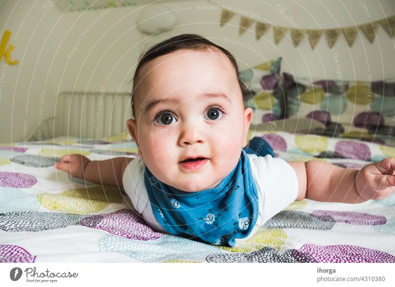 portrait of adorable baby lying babycare babyhood beautiful beauty boy caucasian child childcare childhood closeup cute emotion excitement expression eyes face