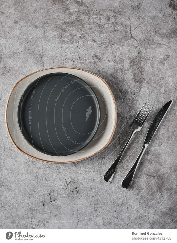 Empty plates, forks on grey concrete background. Top view, concept mockup. spoon studio shot luxury romantic silver dining serving tableware design elegant