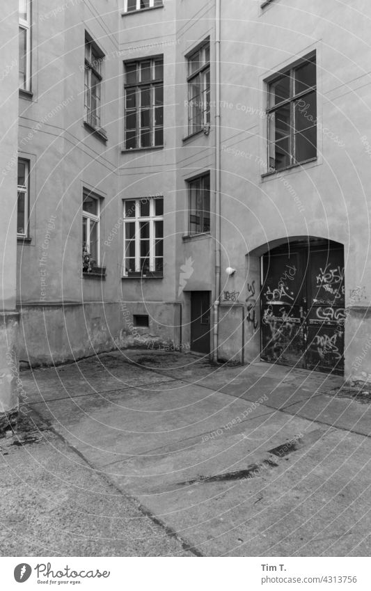 a gateway to a backyard in Berlin Prenzlauer Berg Backyard Interior courtyard b/w Gate entrance Window door Deserted Downtown Town Capital city Day