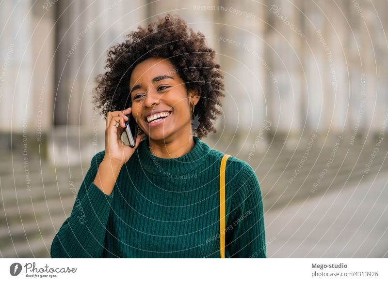 Business woman talking on the phone outdoors. afro business mobile modern style brunette gadget positive concept connection application sms texting