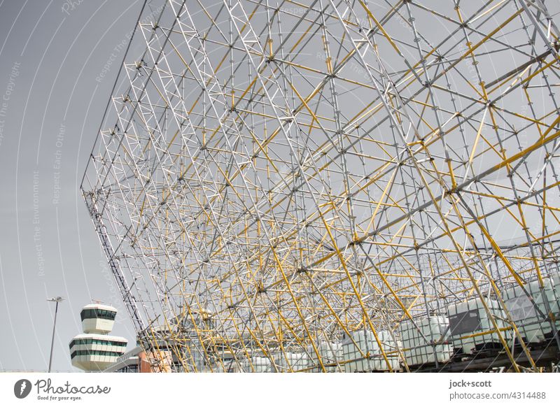 Scaffolding advertising without advertising tarpaulins at the tower airport Tegel Advertising space Construction Airport Berlin-Tegel statics criss-cross Sky