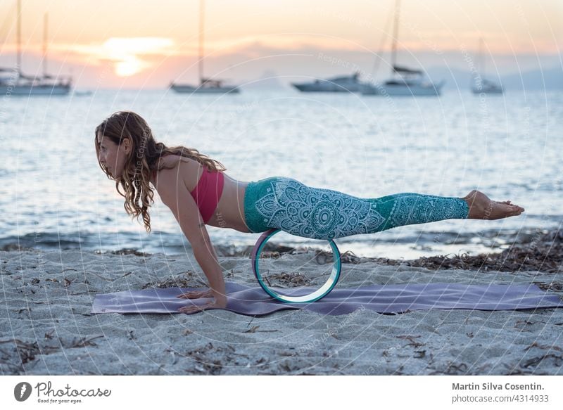 Woman practicing yoga on the beaches of Formentera in Spain balance beautiful beauty body calm energy exercise female fit fitness girl harmony health healthy