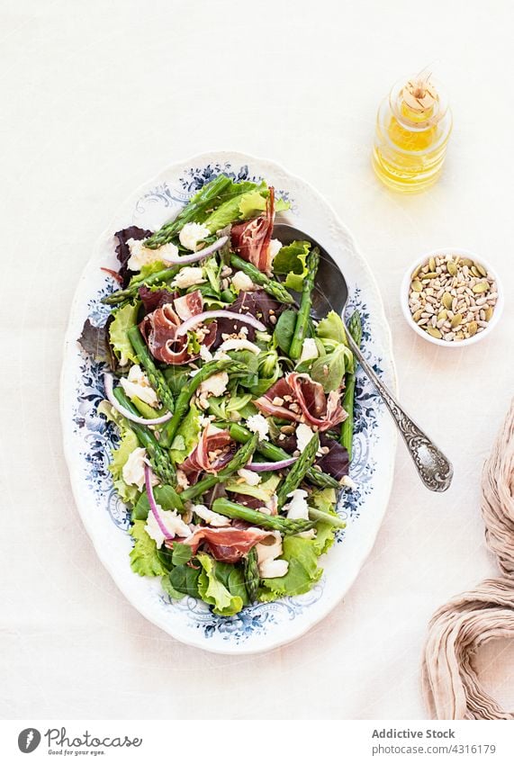 Delicious prosciutto, mozzarella and asparagus salad on table cheese ham serrano gastronomy delicious jamon white background restaurant food fresh cuisine diet