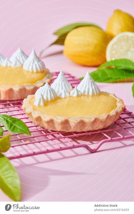 Sweet lemon tarts on pink background dessert whipped cream citrus treat sweet delicious tasty fresh food yummy sour gourmet serve palatable homemade studio