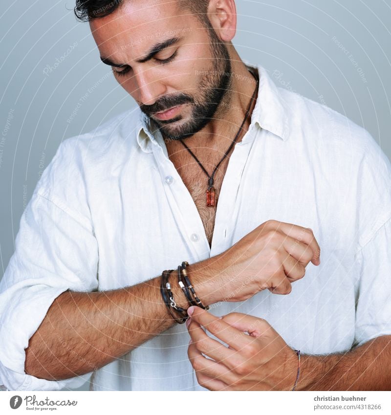 portrait of a young man with arm and neck jewellery Man studio Jewellery necklace Necklace Amber stones fashion Fashion arm jewellery Bracelets Bangle