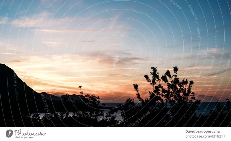 Scenic sunset sky over rippling sea near hilly shores coast evening nature scenery picturesque amazing peaceful seaside horizon seascape tranquil sundown dusk