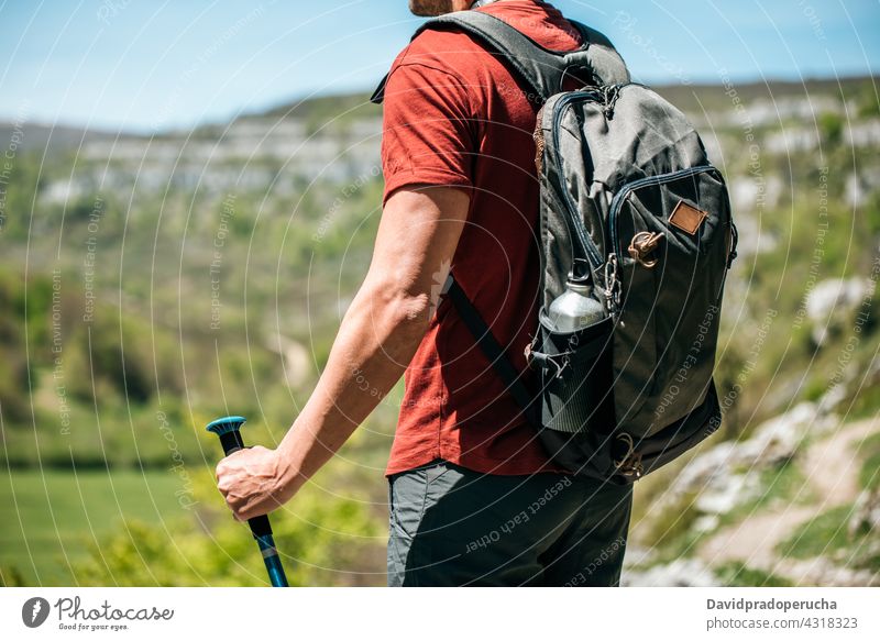 Traveler with backpack on rocky slope hiker admire nature trekking pole wildlife landscape travel cliff tourism traveler editorial adventure explore trip