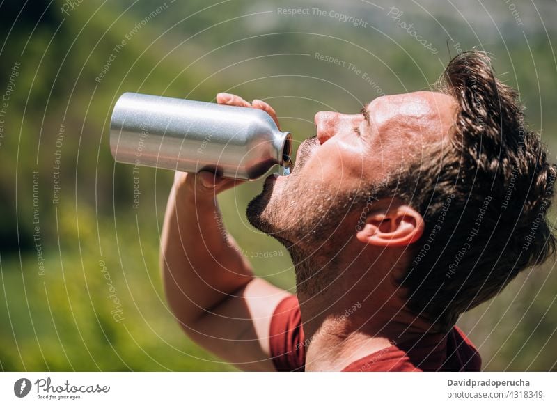 Thirsty man drinking water from reusable bottle tourist thirst reuse zero waste tourism break adventure hot eco friendly sustainable environment traveler