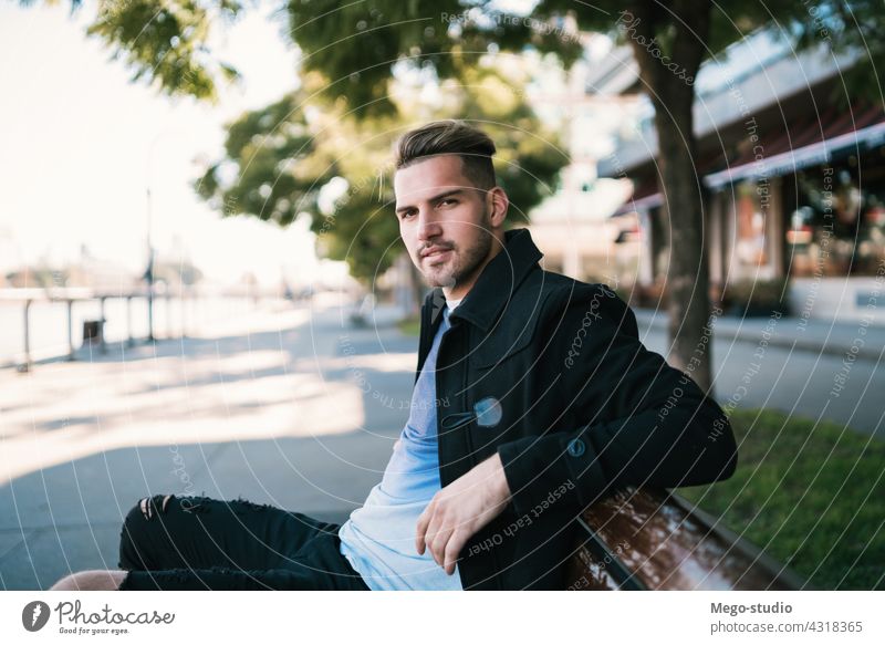 Portrait of young man. adult alone attractive background boy casual caucasian cheerful city clothing confident cool exterior face fashionable friendly handsome