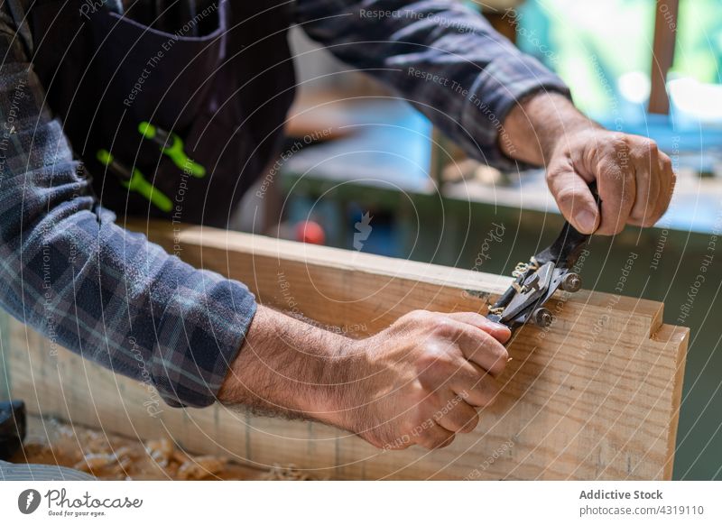 Woodworker shaping wooden plank with spokeshave carpenter woodworker plane man joiner tool workshop shape smooth carpentry craftsman male artisan skill joinery