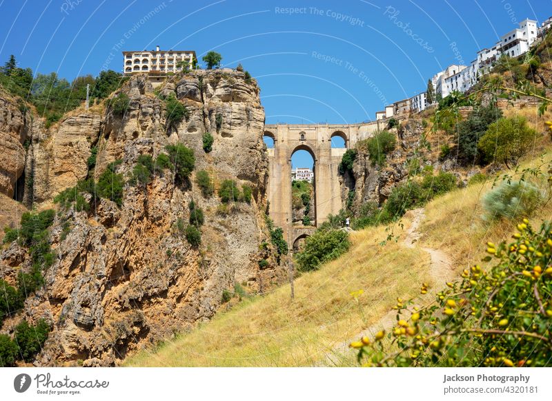 Beautiful view of historic roman bridge in Ronda, Spain ronda andalusia spain summer beautiful medieval arches sevilla countryside cityscape urban sightseeing