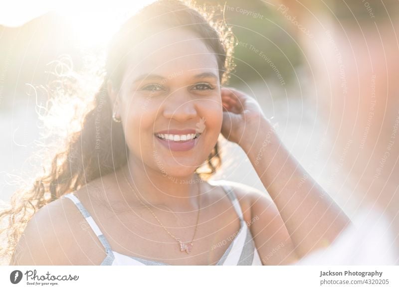 Portrait of a beautiful young woman on the beach by sunset portrait sunny summer algarve portugal brazilian joyful happiness outdoor brunette hispanic enjoy