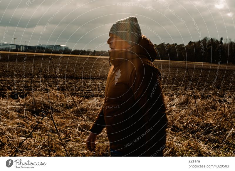 Rentner beim Spaziergang rentner spaziergang draußen herbst winter sonne warme farben feld landschaft erholung bewegung rente gesundheit outdoor sonnenstrahlen