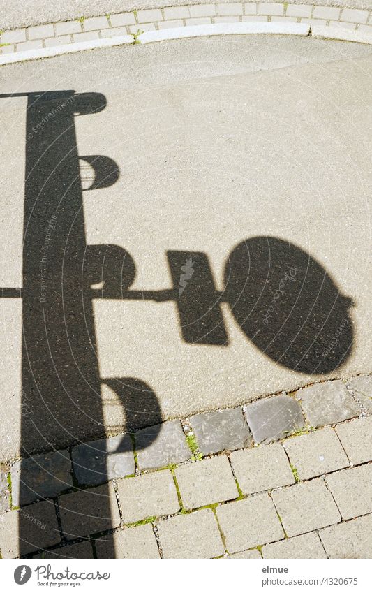 Shadow of a traffic sign and a traffic beacon on a footpath / barrier / danger spot cordon Road sign Footpath forbidden pedestrianised Protective Grating