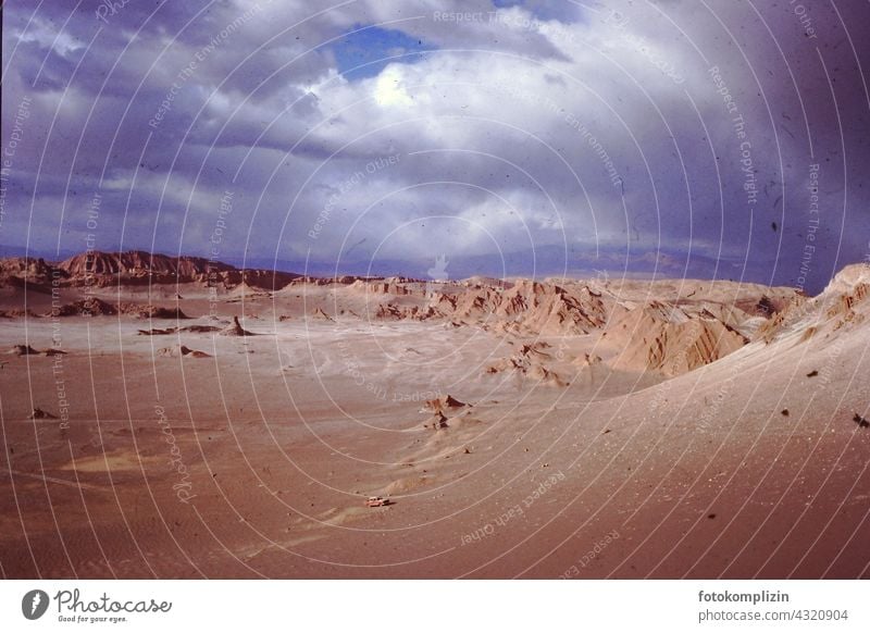 Lunar landscape - wide desert valley with sand dunes and rocky mountains under dark sky Desert Sand Rock chain of hills desert landscape Mystic tranquillity