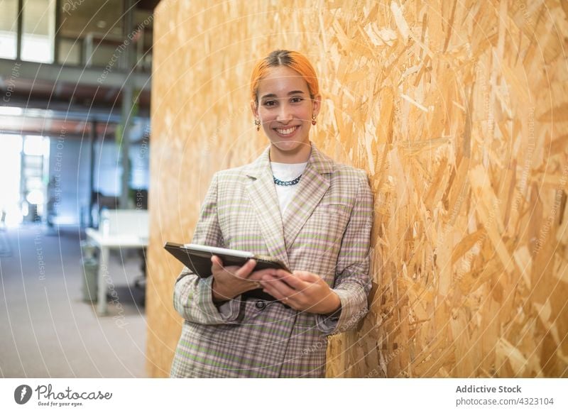 Businesswoman with laptop in modern workplace businesswoman entrepreneur cowork space smile computer office respectable well dressed female gadget device