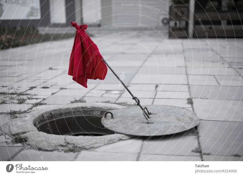 broken and open sewer cover close up . Road repairs concept attention breaking hard highway job processing warning dirty hole pipe under underground utility