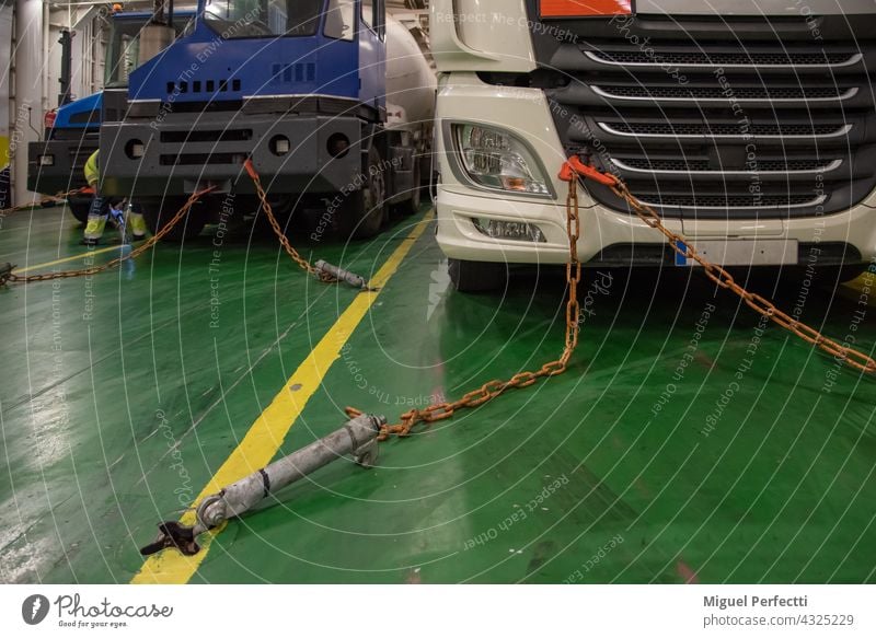 Preparing the handles and chains to the truck to start the safe journey in the hold of a ship. boat ferry security moored warehouse sailing dangerous goods