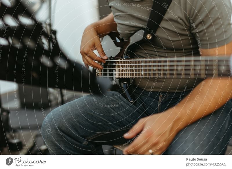 Man playing bass guitar bassist Bass guitar String instrument Music Musician Musical instrument Hand Make music Electric bass Rock music Sound Guitar Concert