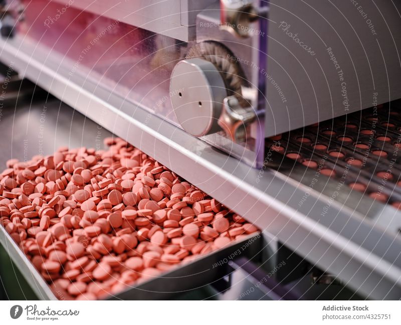 Modern pharmaceutical machine with pills at factory conveyor manufacture laboratory machinery production medicine equipment industry professional technology