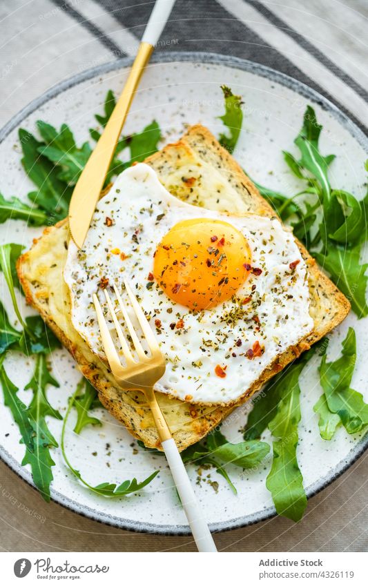 Toast with eggs and cheese food healthy meal plate cuisine dish lunch closeup vegetable diet dinner breakfast bread yolk tasty appetizer arugula background