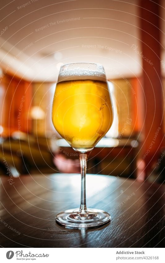 Glass of beer alcohol ale appetizer bar beverage bokeh brewery cold concept craft drink foam food glass golden pub selective focus snack table thirsty vintage