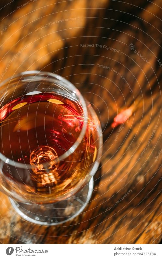 Cognac glass on wooden table with natural light alcohol background barman bartender beverage bokeh bourbon cocktail cognac drink food lights liquor mixologist