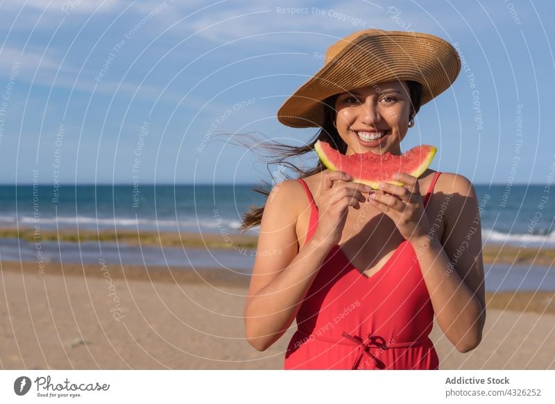 Content woman eating watermelon on beach summer vacation sea bikini holiday cheerful female enjoy swimwear smile fresh swimsuit tasty seashore delicious happy