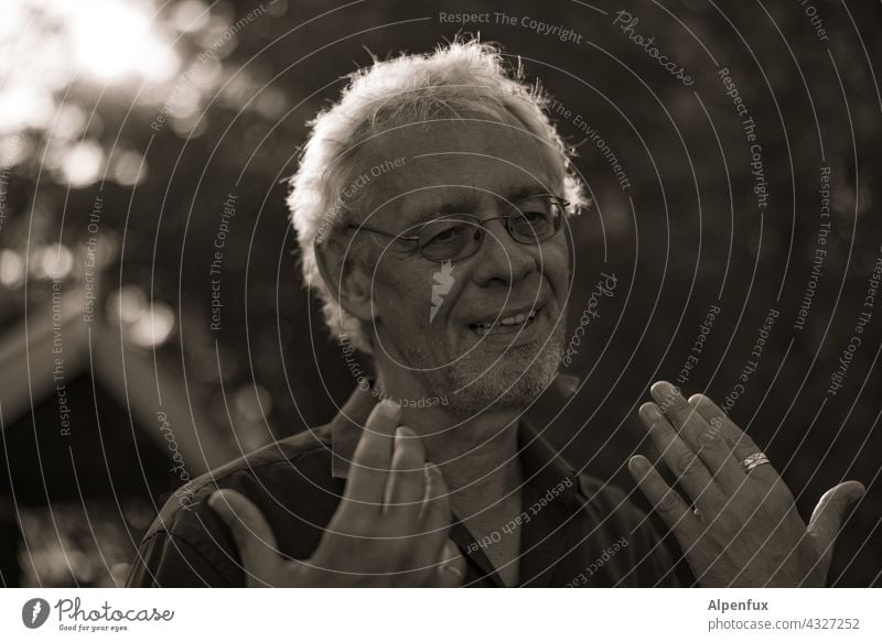 Erklärbär | Park Tour HH 21 Man Masculine portrait Back-light Adults Shallow depth of field Face Gray-haired Explain hands Senior citizen Day Authentic