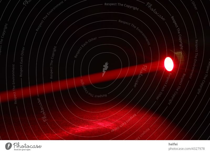 Laser point of a light barrier with red background Red rays jet Digital Shadow Technology Electrical equipment Laser position indicating system Club