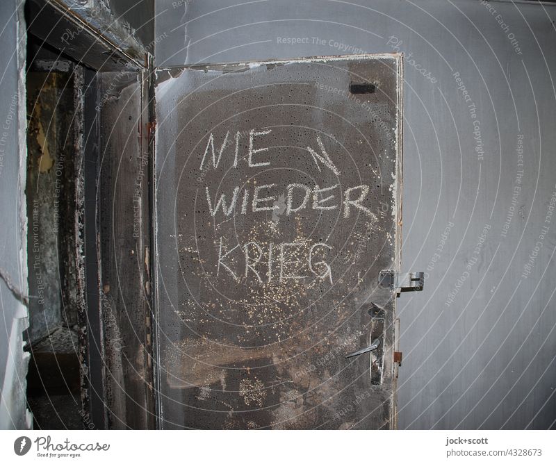 Never again war door frowzy Dirty lost places Ravages of time Apocalyptic sentiment Decline Ruin Open Handwriting Capital letter German Old