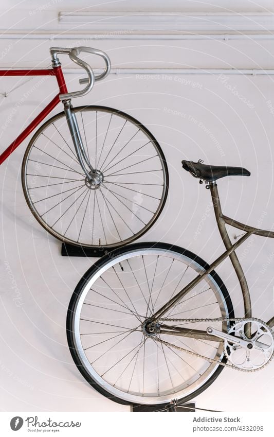 Bicycles hanging on wall in garage bike bicycle workshop old repair service design metal transport vehicle convenient shabby grunge weathered metallic element