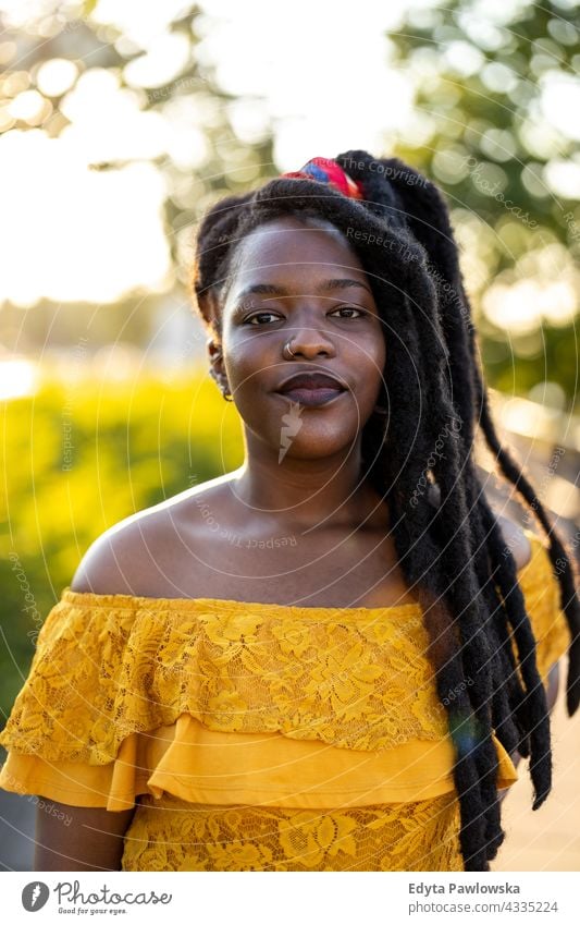 Portrait of beautiful young woman outdoors dreadlocks proud real people city life African american afro american Black ethnicity sunny sunset outside girl