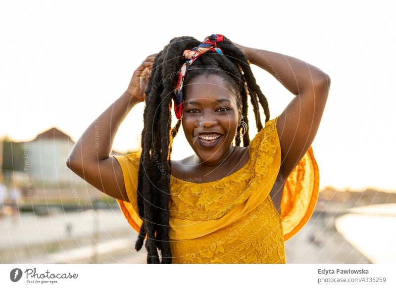 Beautiful young woman enjoying the outdoors at sunset dreadlocks proud real people city life African american afro american Black ethnicity sunny outside girl