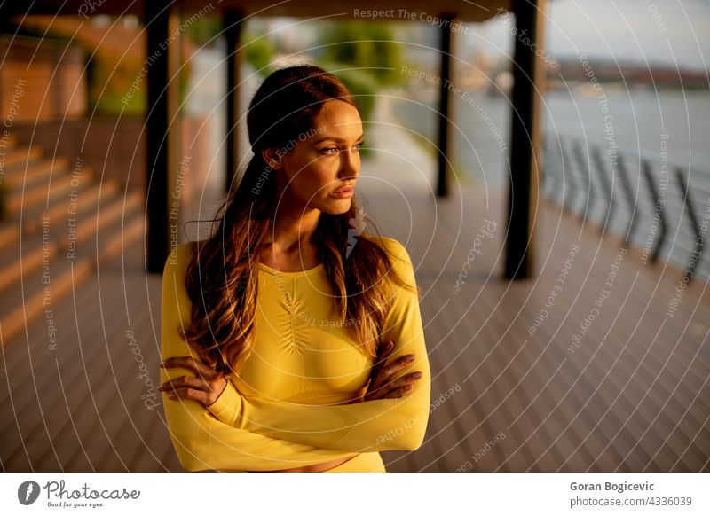 Young woman resting during training after jogging body beautiful fitness female attractive riverside lifestyle healthy young run vitality runner athlete break