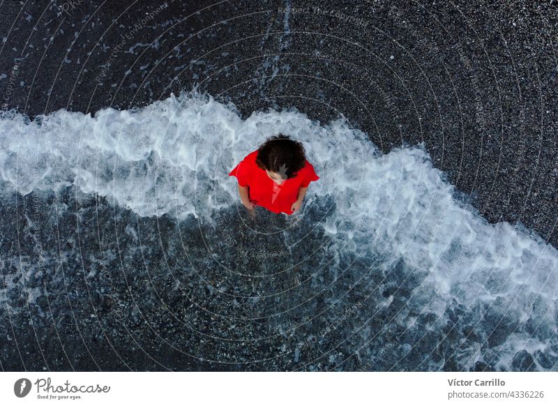 top view of a woman in a red dress  with sea foam background water wave beach ocean blue nature waves summer splash spray coast recreation sky outdoors model