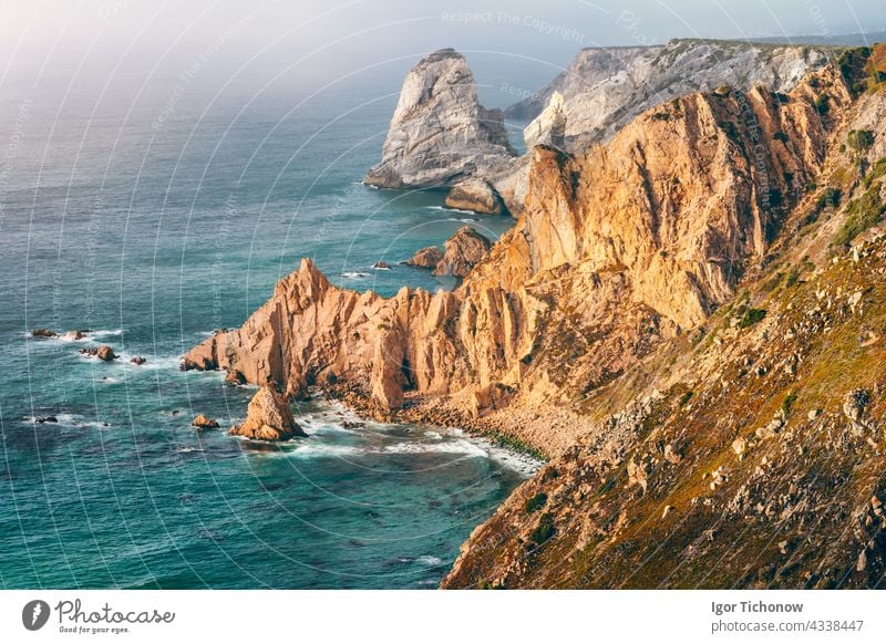 Sintra, Portugal. Rocky coastline between Cape Roca and Praia da Ursa in evening sunset light and Atlantic Ocean portugal ocean ursa jagged cape travel outdoors