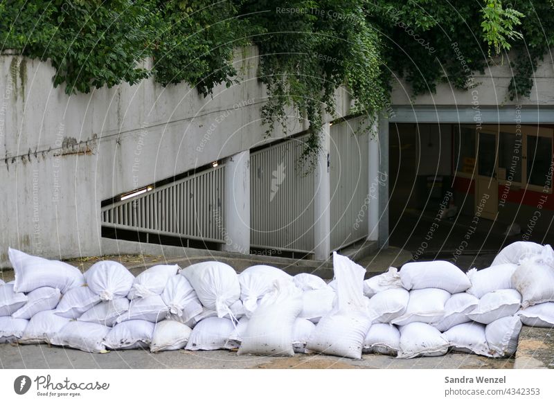 Sandbags in front of an underground car park Flood Summer 2021 heavy rain Constant rain Storm High tide bank flooded Natural hazards building insurance